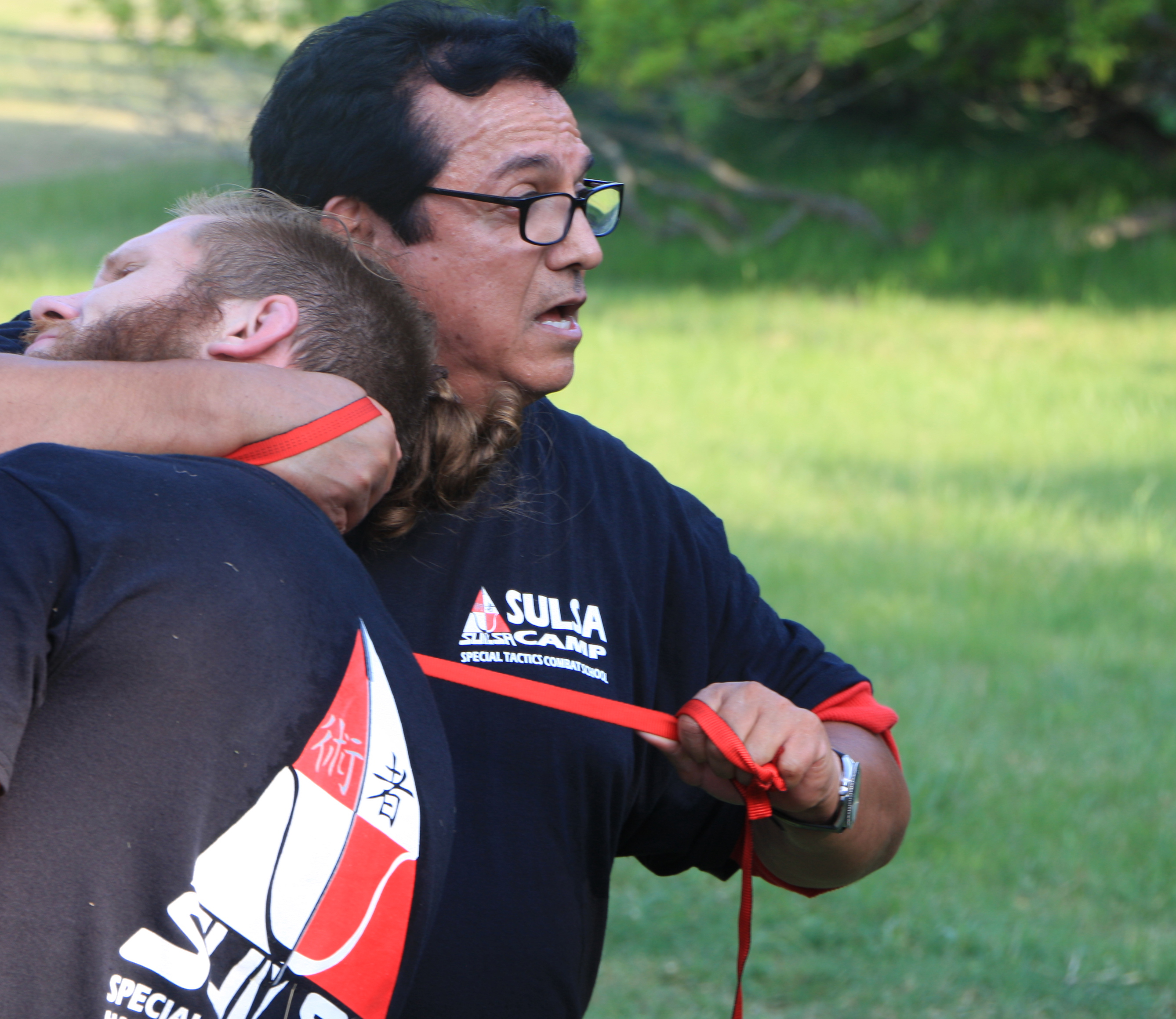 Master Corona demonstrating a rope-based control technique at Sulsa Camp