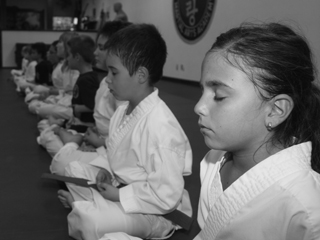 Children in seated meditation during a martial arts class